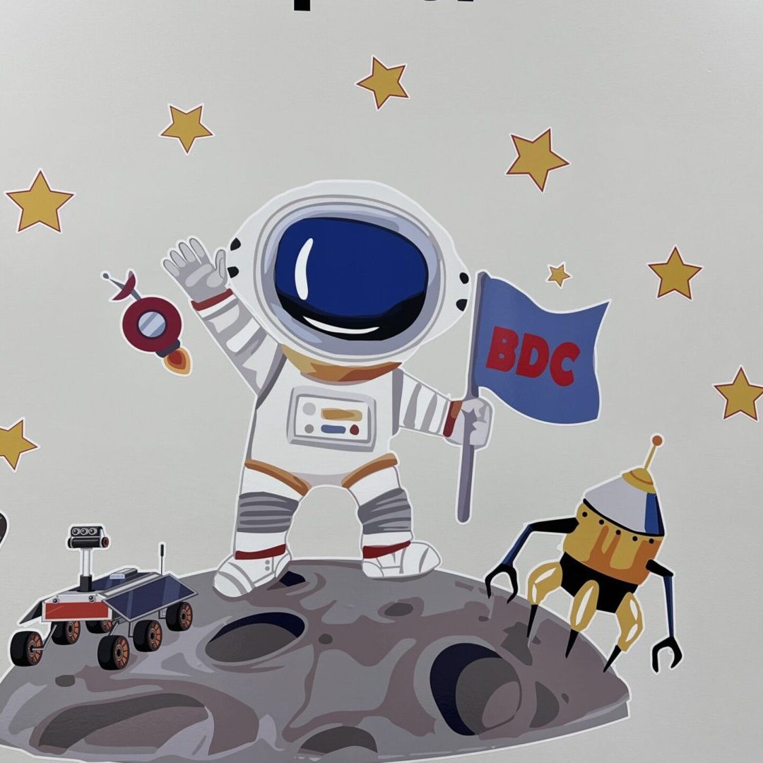 Astronaut holding flag, surrounded by stars.